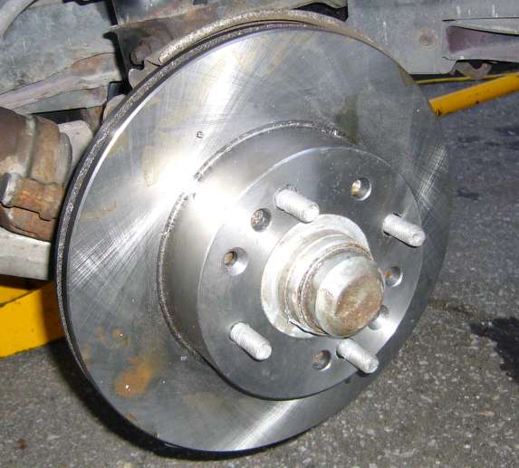 Image of 4 piston rotor being test fitted on 4 lug hub